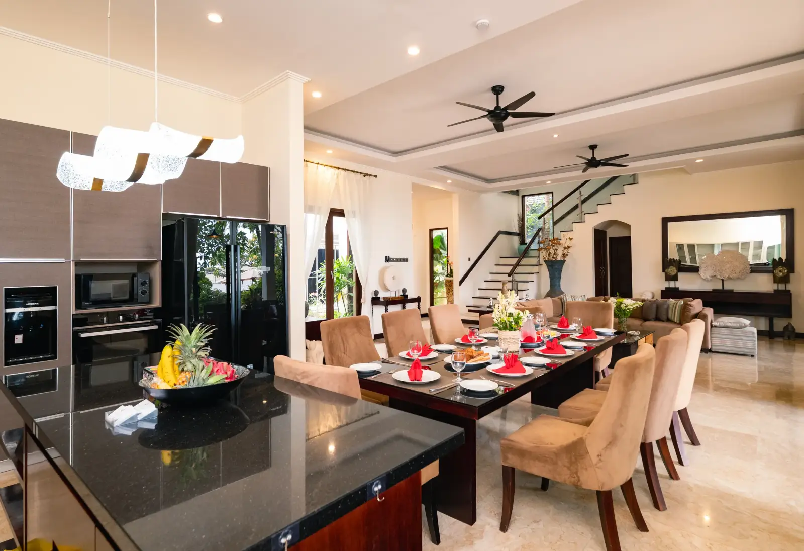 Villa Rayana — Kitchen island with the dining area and staircase
