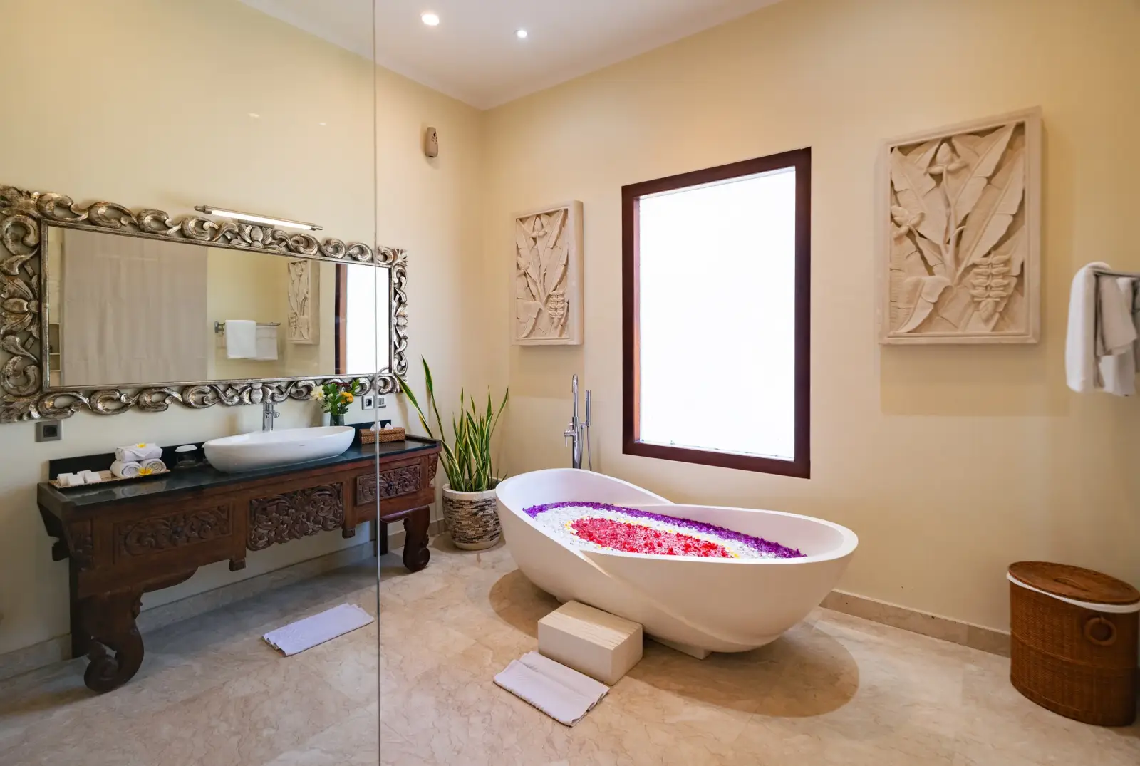 Villa Rayana — Bathroom with carved stone panels and flower bath